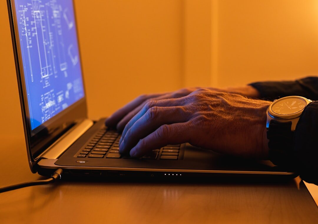 writer typing on laptop at night